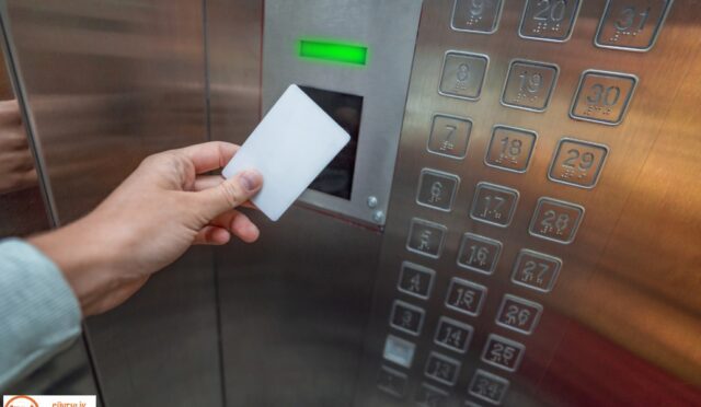 Person using a key card in an elevator